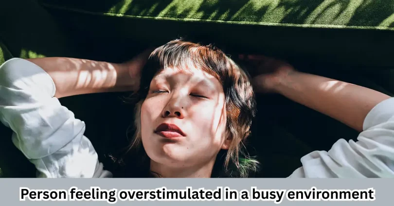 Person feeling overstimulated in a busy environment